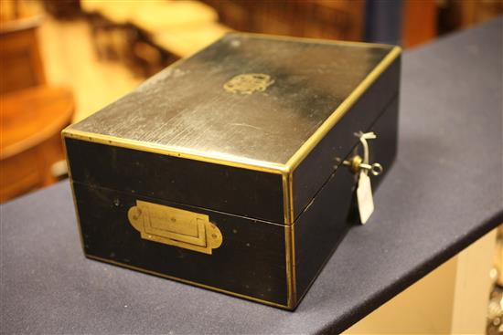 A Victorian brass mounted ebonised travelling fitted toilet box containing ten engine turned silver mounted jars, 13.25in.